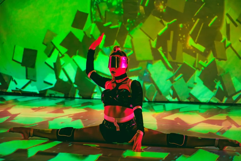 Reality Collapse dancer under projection mapped visuals